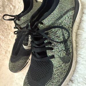 Nike Women’s Flyknit Sneakers in Black and Green